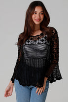 woman wearing black cotton crochet top with scalloped sleeves and flared hem - Boho crochet blouse Australia.