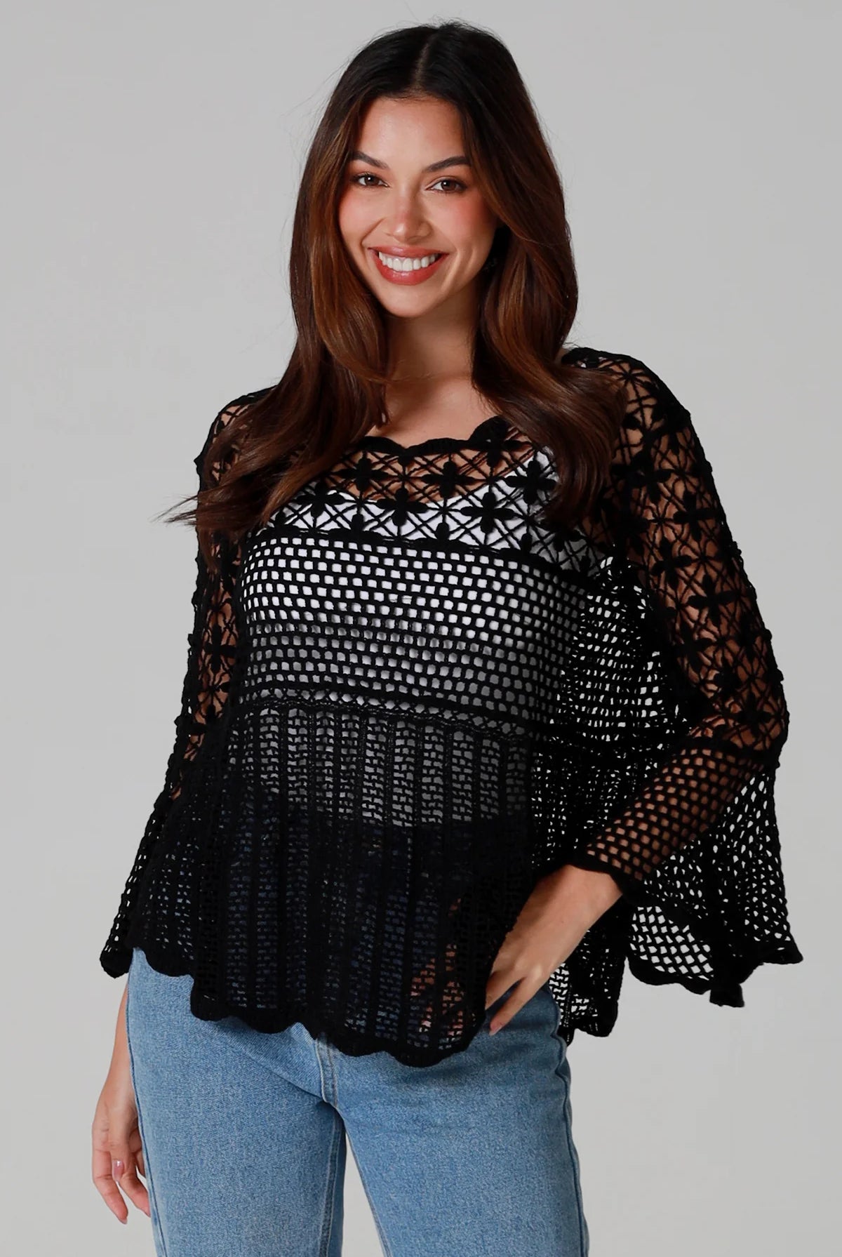 woman wearing black cotton crochet top with scalloped sleeves and flared hem - Boho crochet blouse Australia.