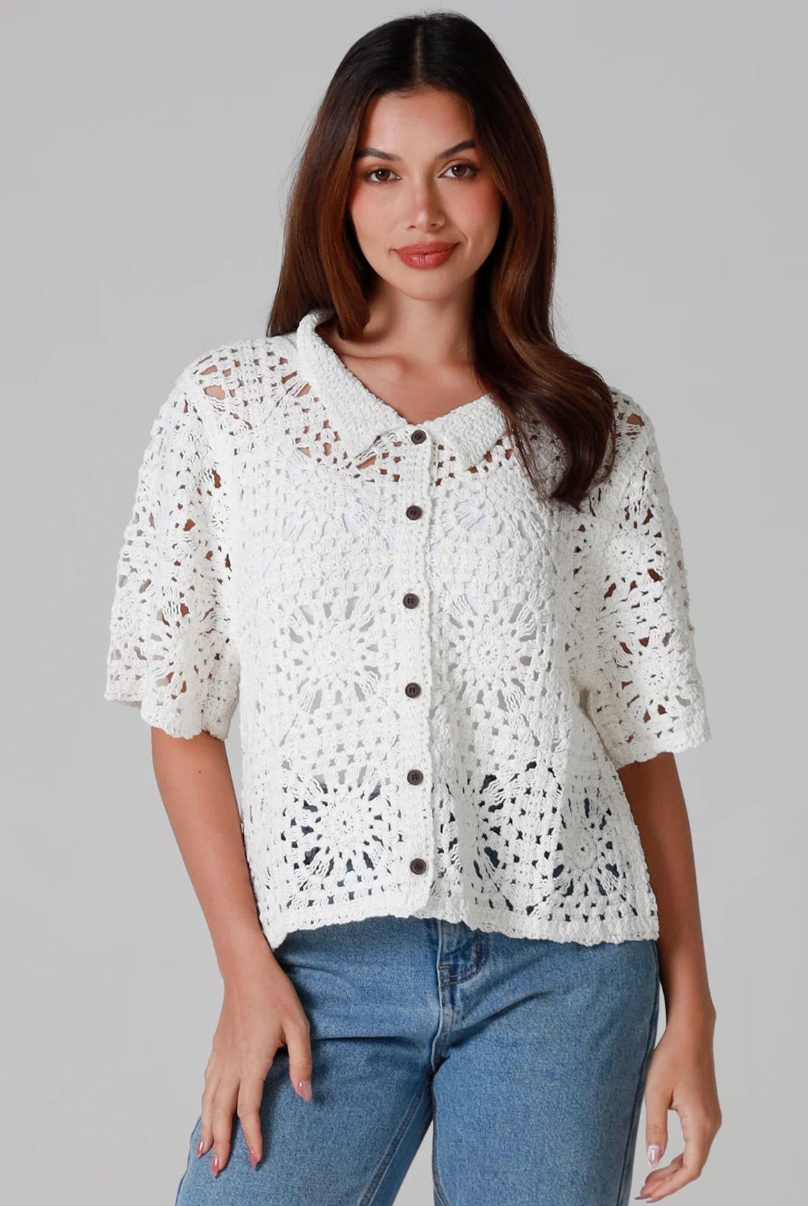 Woman wearing white cotton crochet cardigan with collar and buttons - boho knit top Australia.