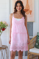 Woman in pink embroidered cotton mini dress with lace V-neck and scalloped hem – Bohemian Love Runway.