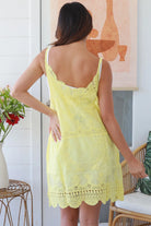 Woman in lemon yellow embroidered cotton mini dress with lace neckline and V-back – Bohemian Love Runway