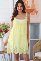 Woman in lemon yellow embroidered cotton mini dress with lace neckline and V-back – Bohemian Love Runway