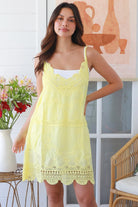 Woman in lemon yellow embroidered cotton mini dress with lace neckline and V-back – Bohemian Love Runway