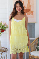 Woman in lemon yellow embroidered cotton mini dress with lace neckline and V-back – Bohemian Love Runway