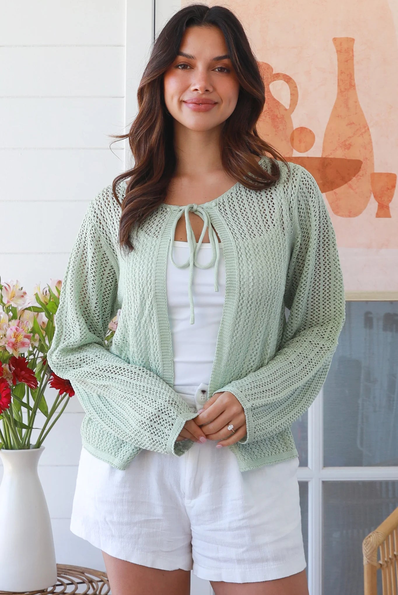 Woman wearing sage cotton crochet cardigan – textured boho statement layer by Bohemian Love Runway