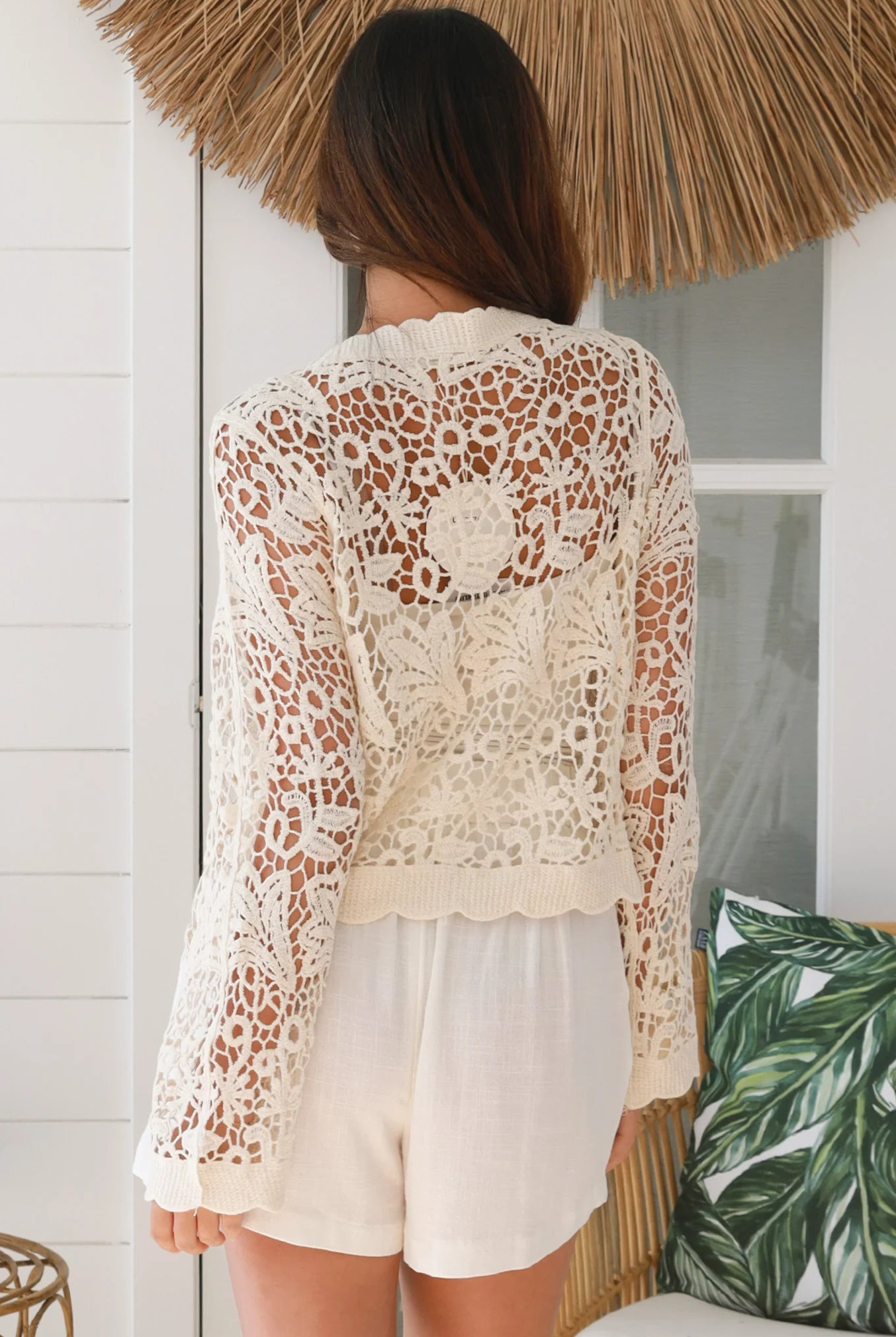 Bohemian woman in cream crochet cotton jacket with scalloped lace edges and button front - versatile boho jacket Australia
