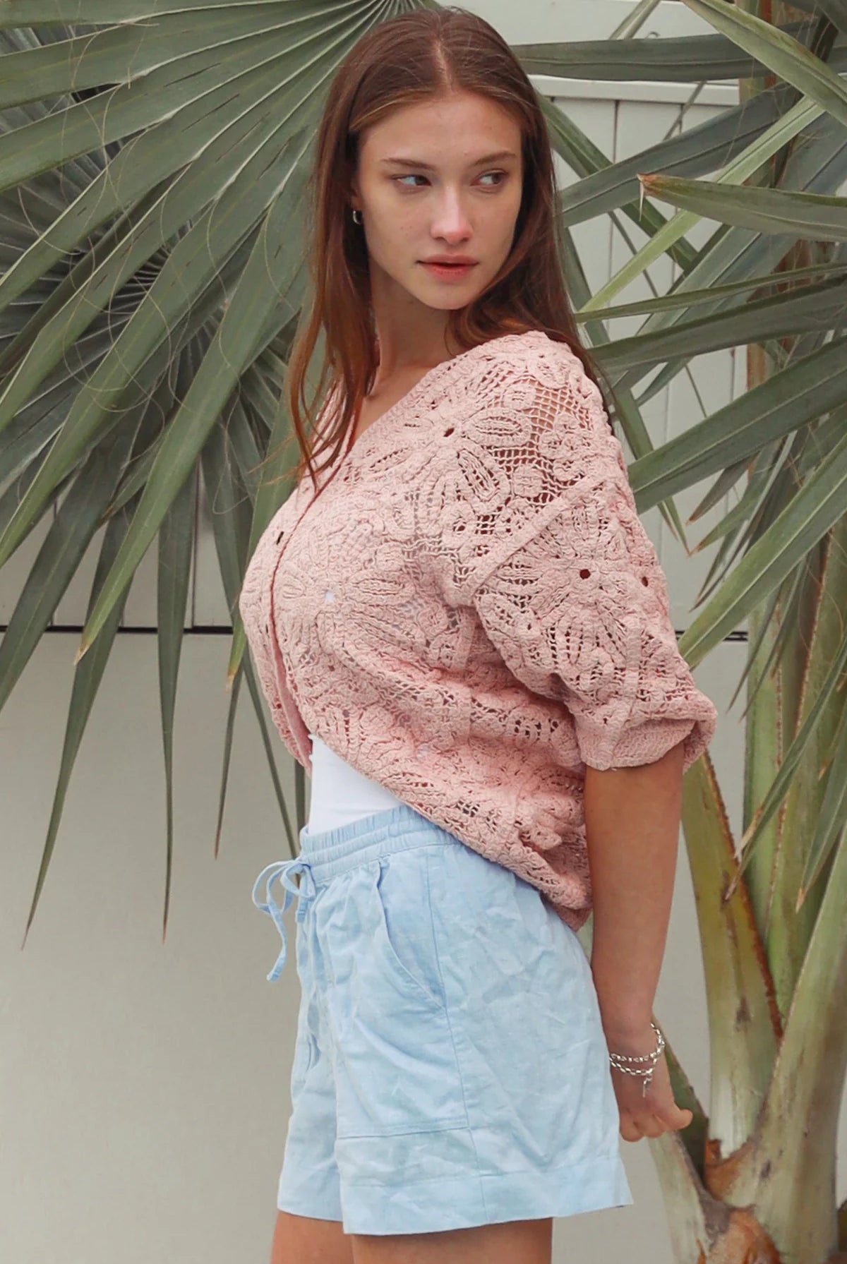 Pink embroidered cotton lace cardigan with V-neckline, button-through front and softly rounded hem