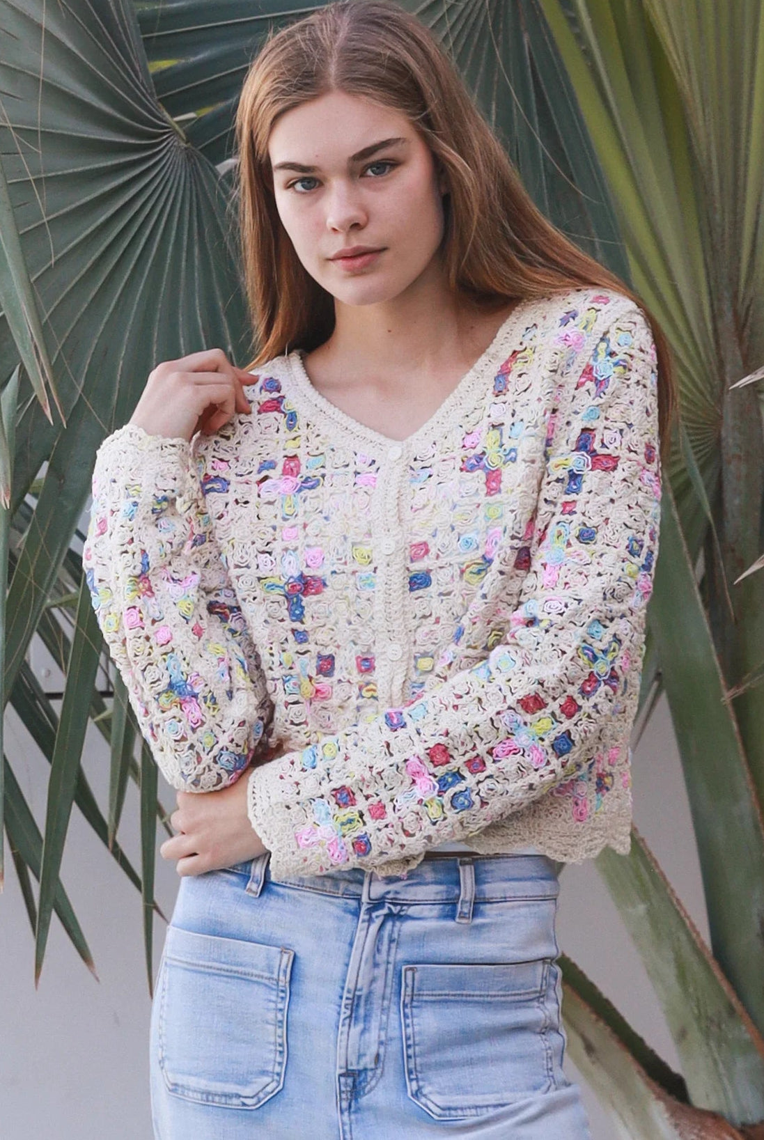 Woman wearing pastel embroidered cotton boho cardigan with textured crochet weave and relaxed vintage - inspired styling in Australia.
