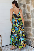 Woman in The Rio Jumpsuit — relaxed wide leg tropical boho jumpsuit with contrast side stripe | Bohemian Love Runway
