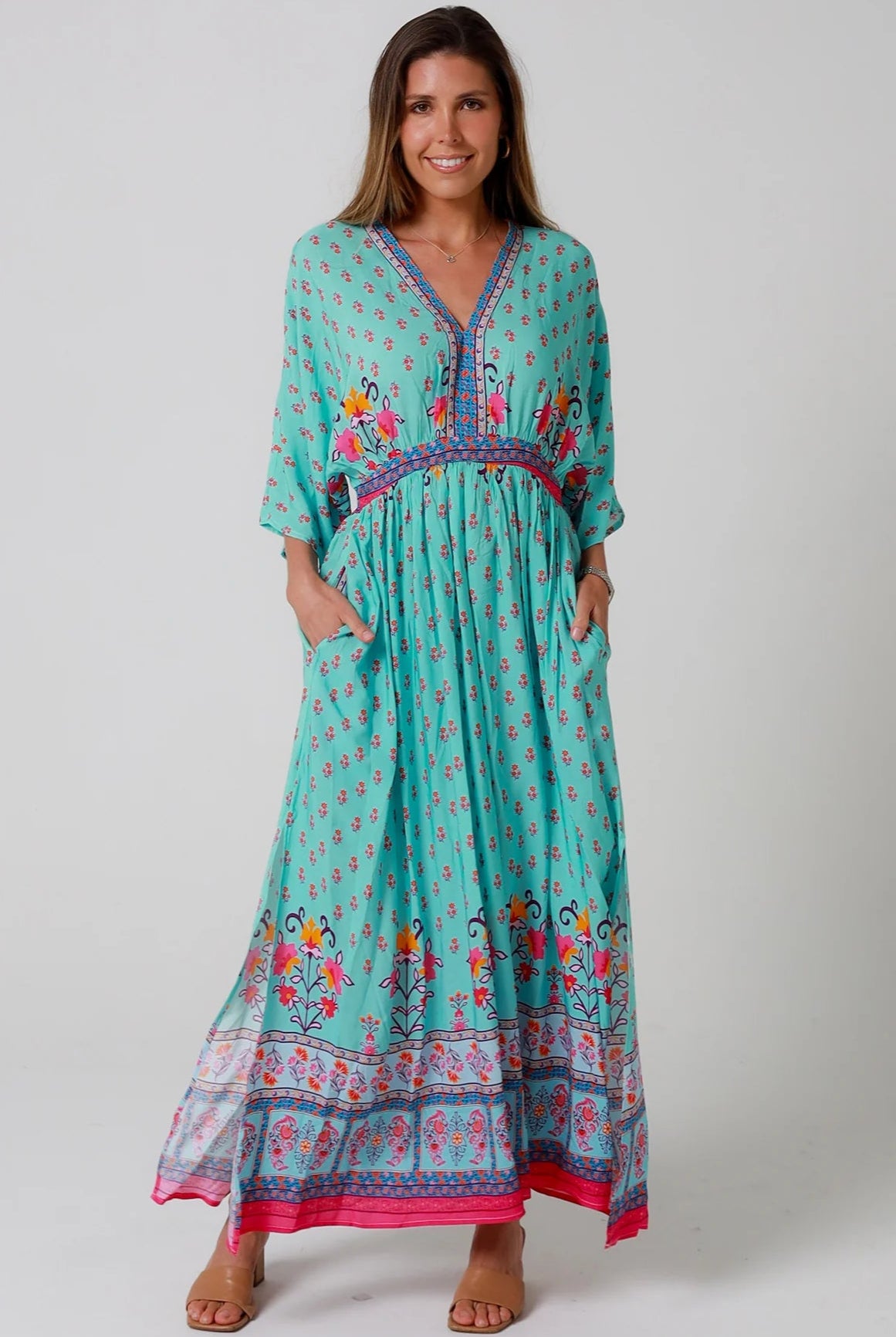 Woman in turquoise floral boho maxi dress with kimono sleeves and border print - Amara Field Maxi Dress Australia.