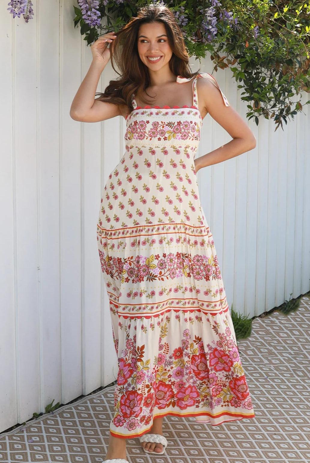 Cream rayon boho maxi dress with blush and rose floral print, tie shoulders, lace trim, and border hemline — Love at First Bloom