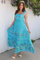 Woman wearing vintage floral boho tie-shoulder maxi dress with border print, rickrack lace and tiered hem – Dreamcatcher Isle of Bloom