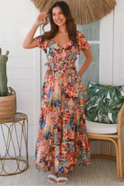 Bohemian maxi dress in butterfly floral print with elastic waist, smocked back, pockets and dramatic tiered hemline