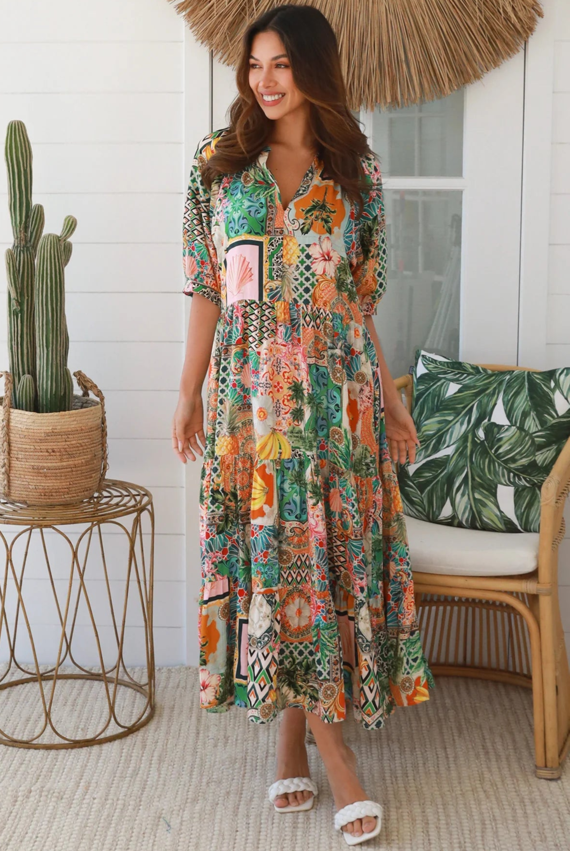Woman in colourful tropical patchwork rayon midi dress with palms hibiscus and shells - boho chic island style Australia