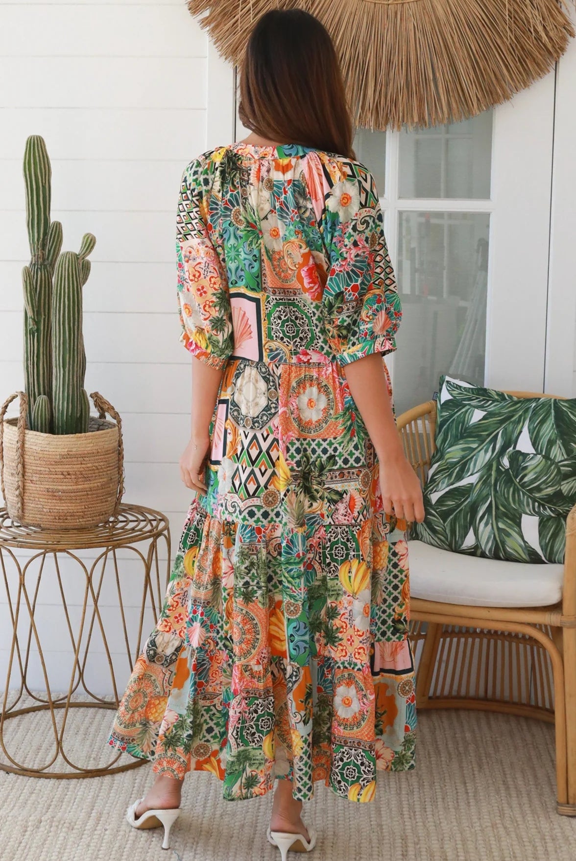 Woman in colourful tropical patchwork rayon midi dress with palms hibiscus and shells - boho chic island style Australia