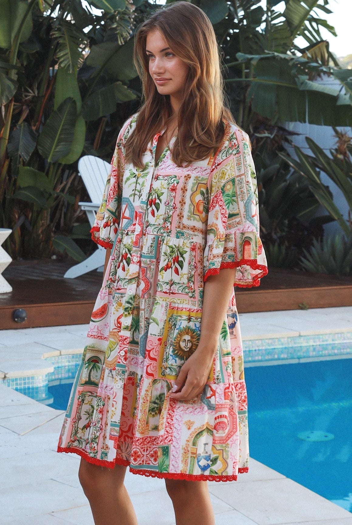 Woman wearing Zimmy tiered mini dress in rayon with button-through front and bohemian print by Salty Palm Australia