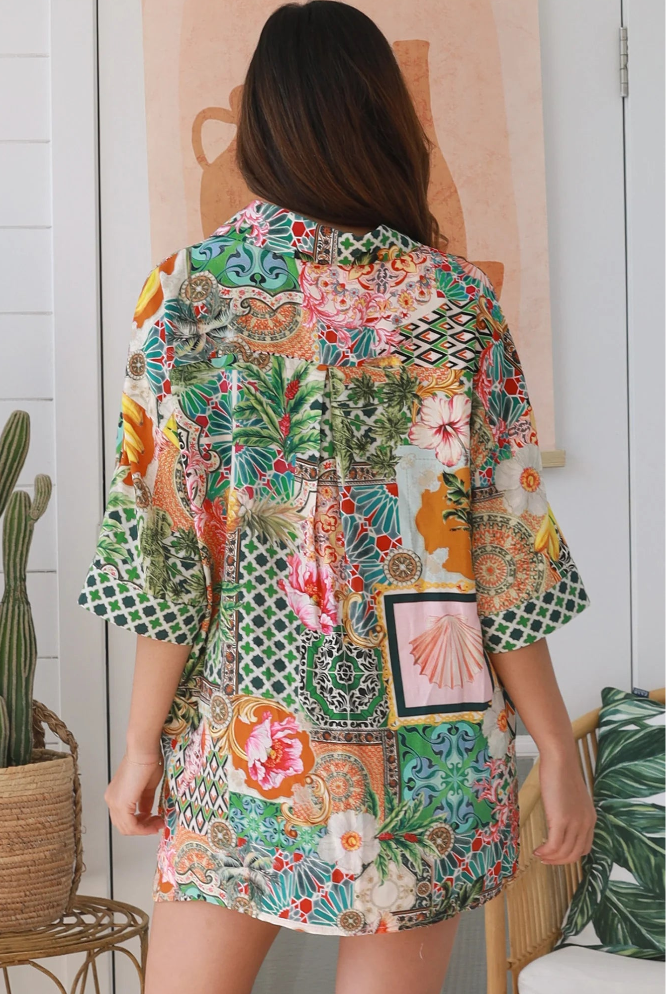 “Woman wearing tropical boho rayon shirt with border sleeves and pleated back – Amira Island Dream Shirt by Dreamcatcher, Bohemian Love Runway”