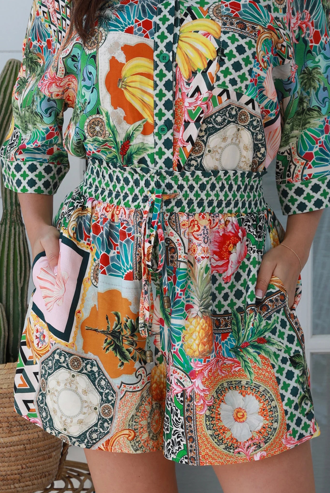 “Woman wearing tropical boho rayon shorts with border waistband and tie front – Amira Island Dream Shorts by Dreamcatcher, Bohemian Love Runway”