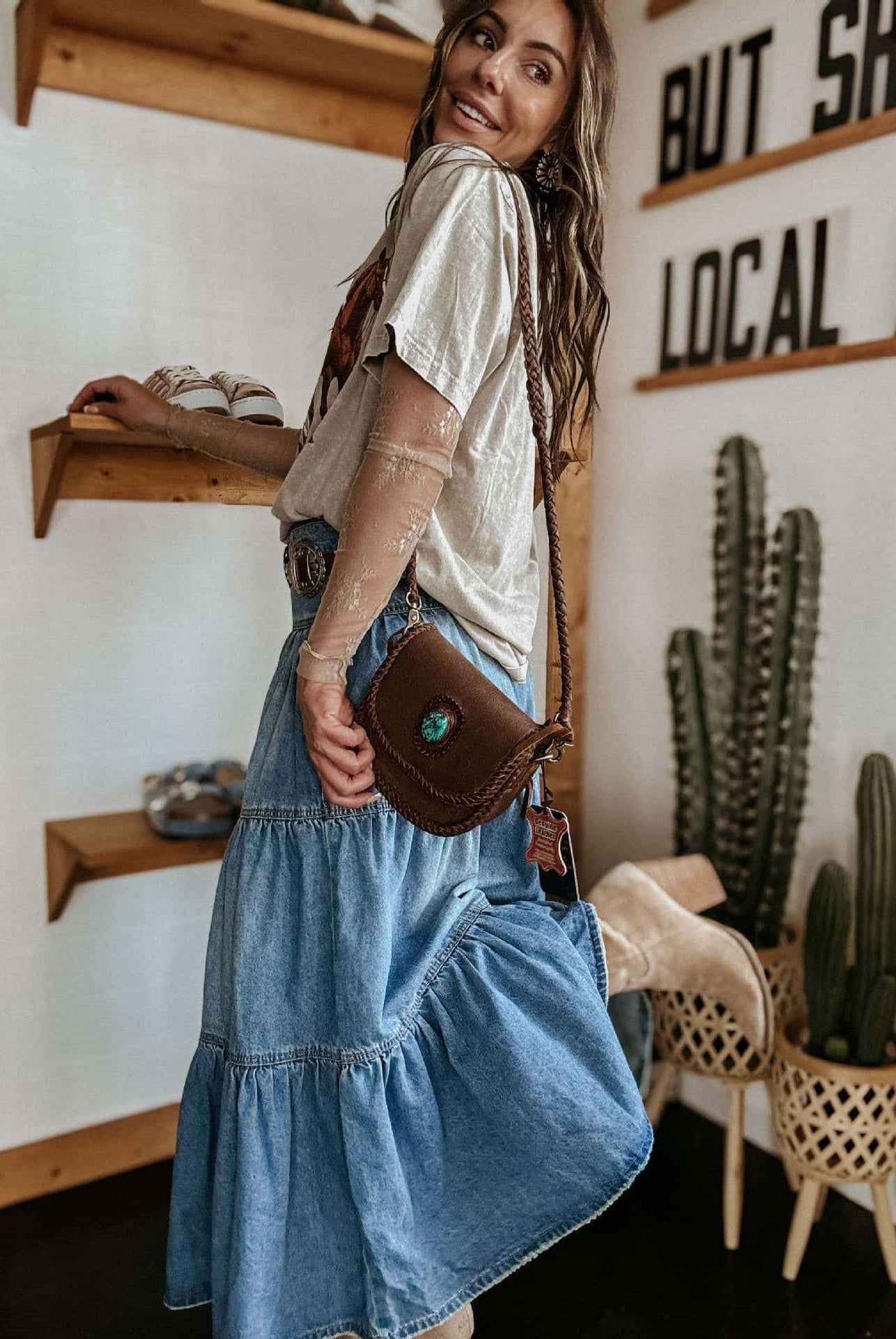 Woman in high-waisted tiered indigo cotton denim maxi skirt with button front - Bohemian Love Runway.