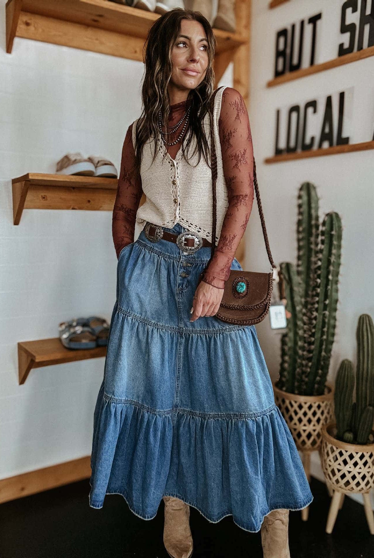 Woman in high-waisted tiered indigo cotton denim maxi skirt with button front - Bohemian Love Runway.