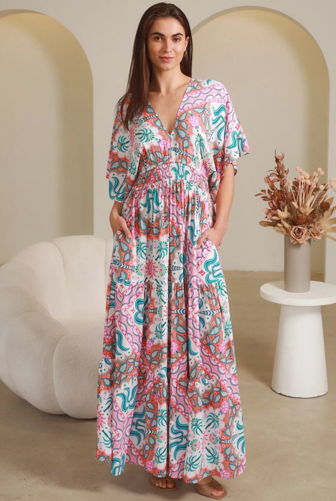 Model twirling in Fiorella Maxi Bohemian dress with pink aqua coral teal print — Dreamcatcher Dresses Australia