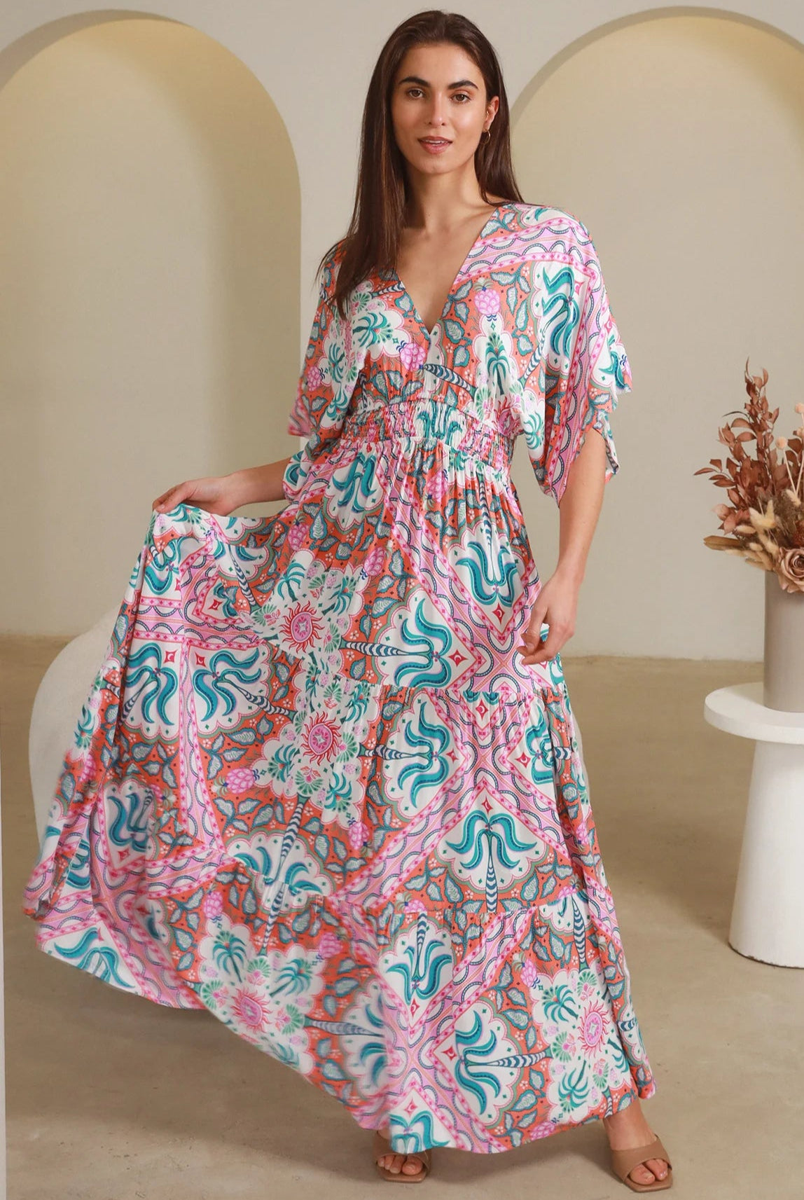 Model twirling in Fiorella Maxi Bohemian dress with pink aqua coral teal print — Dreamcatcher Dresses Australia