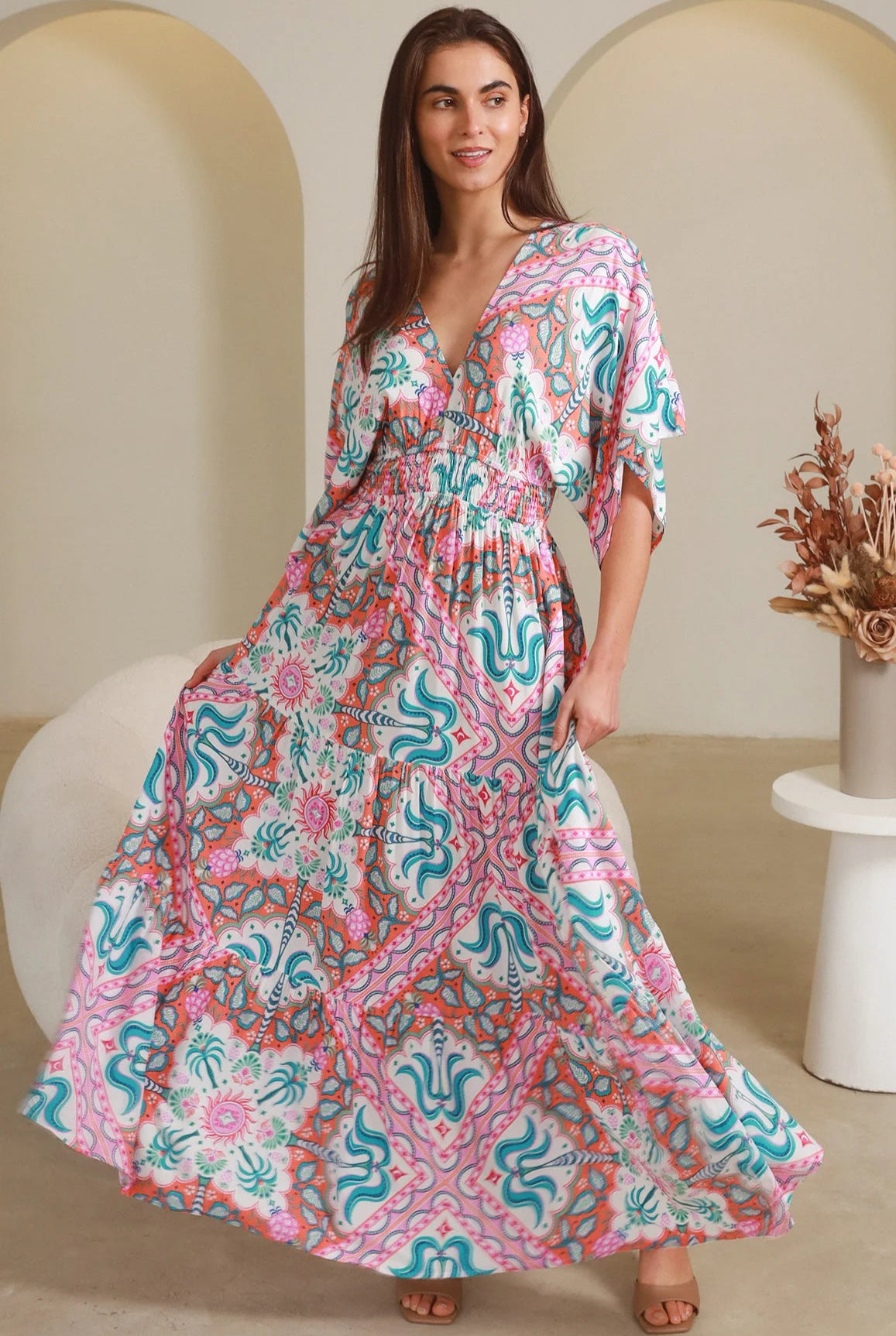 Model twirling in Fiorella Maxi Bohemian dress with pink aqua coral teal print — Dreamcatcher Dresses Australia