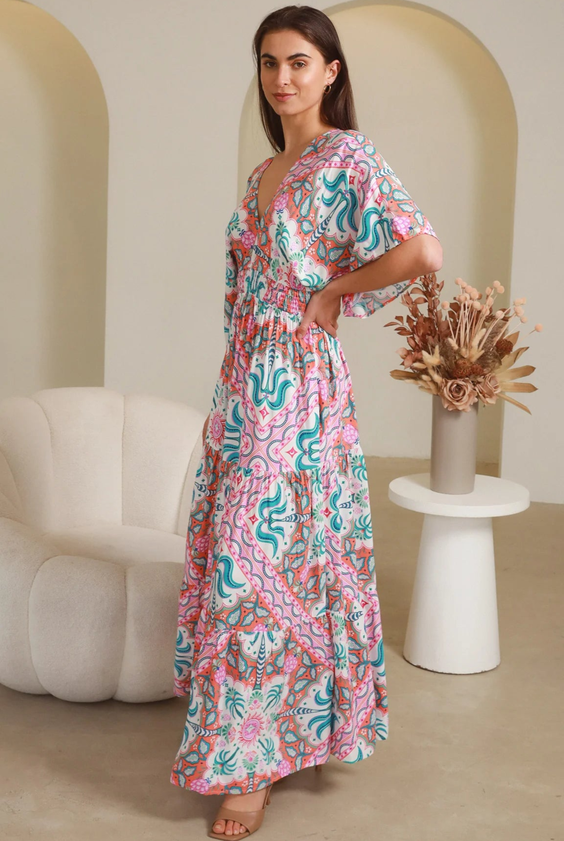 Model twirling in Fiorella Maxi Bohemian dress with pink aqua coral teal print — Dreamcatcher Dresses Australia