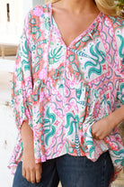 Model wearing Fiorella Boho Top in pink aqua coral teal print with voluminous sleeves - boho blouse Australia
