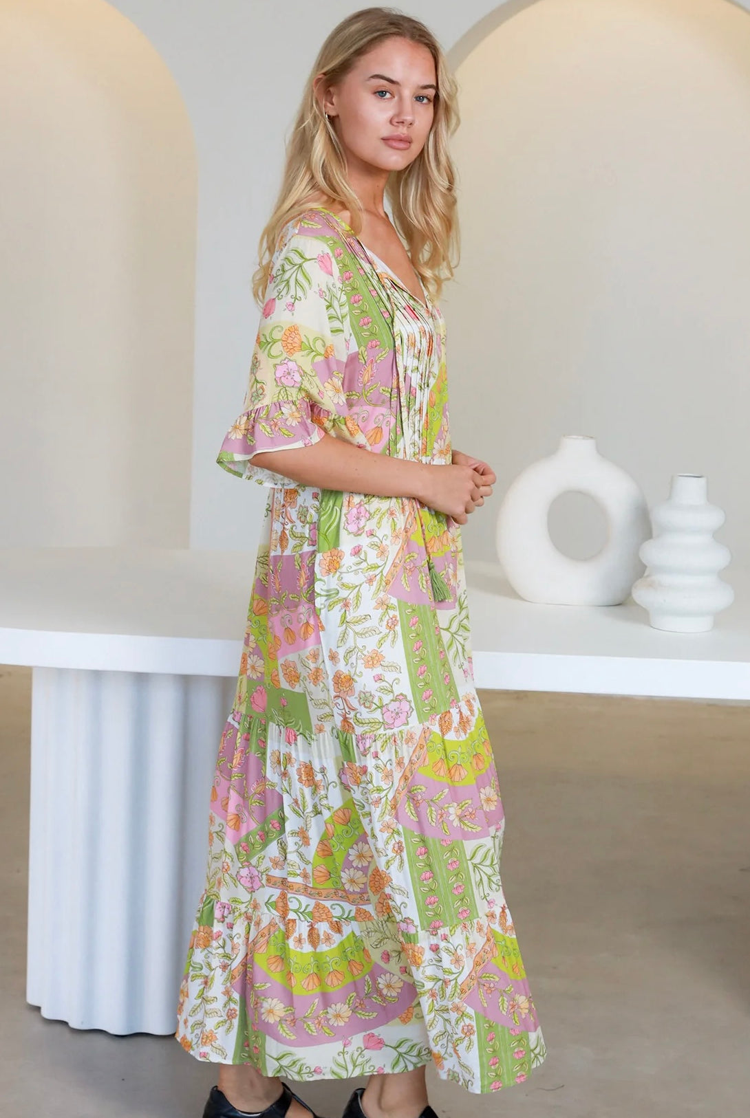 “Woman in vintage floral boho midi-maxi dress with tassel ties, frilled sleeves and tiered skirt – boho midi dresses Australia”