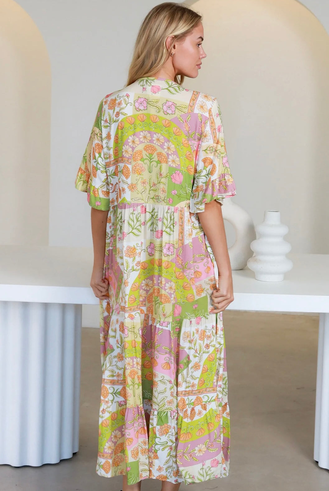 “Woman in vintage floral boho midi-maxi dress with tassel ties, frilled sleeves and tiered skirt – boho midi dresses Australia”