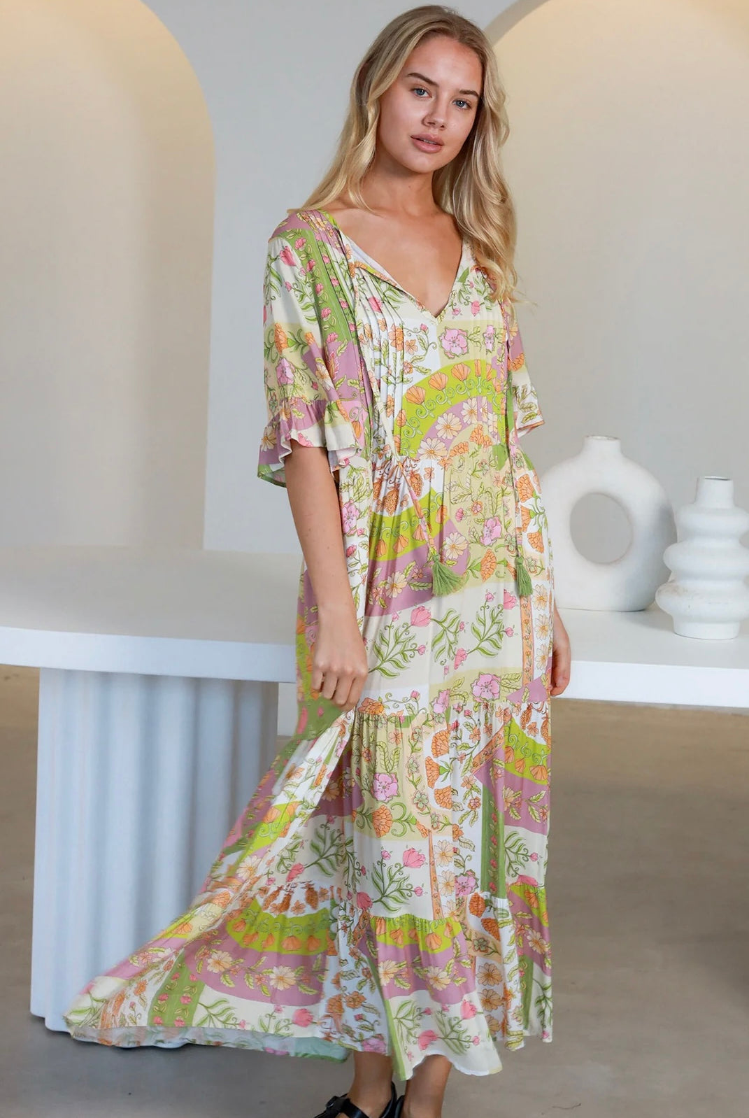 “Woman in vintage floral boho midi-maxi dress with tassel ties, frilled sleeves and tiered skirt – boho midi dresses Australia”