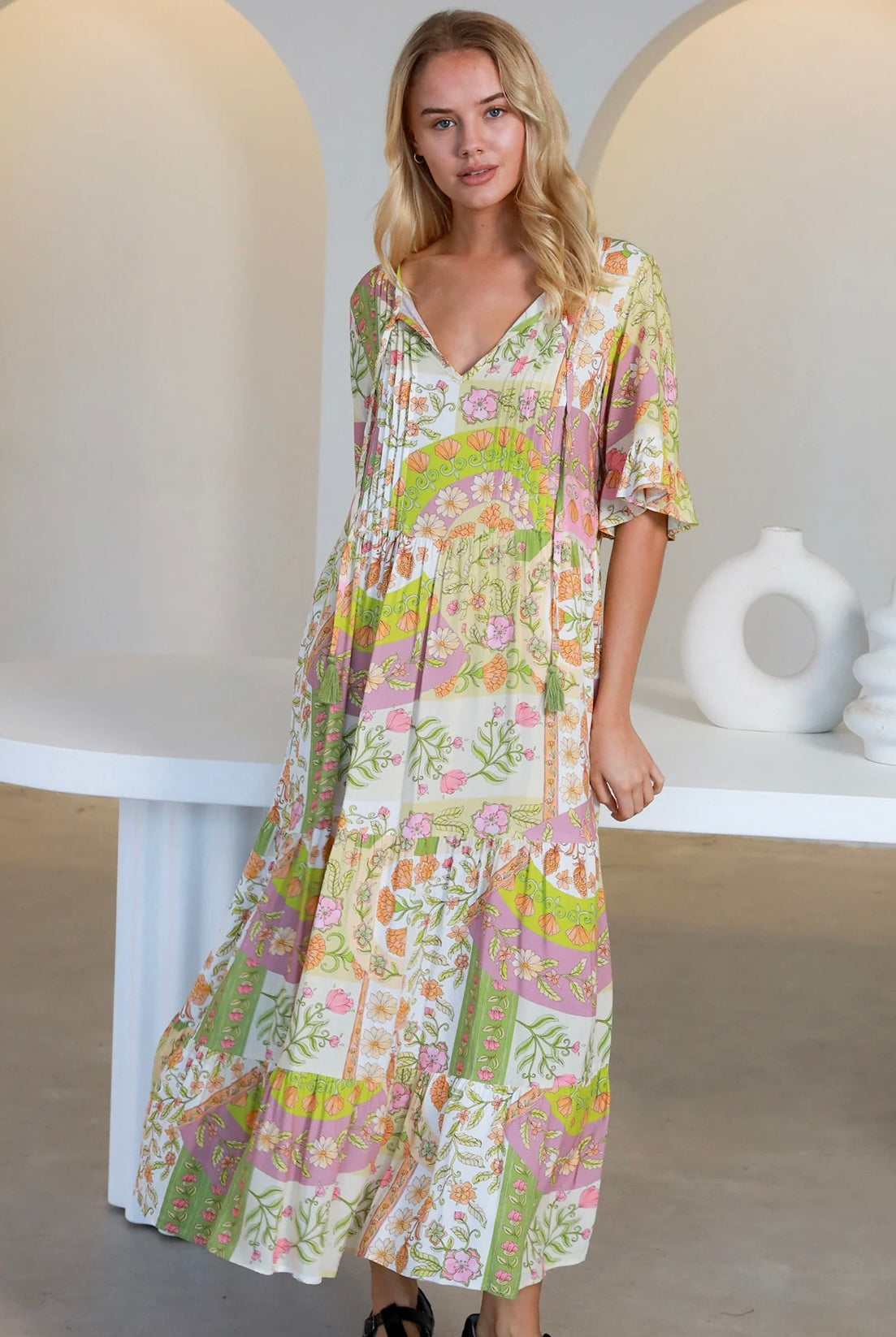 “Woman in vintage floral boho midi-maxi dress with tassel ties, frilled sleeves and tiered skirt – boho midi dresses Australia”