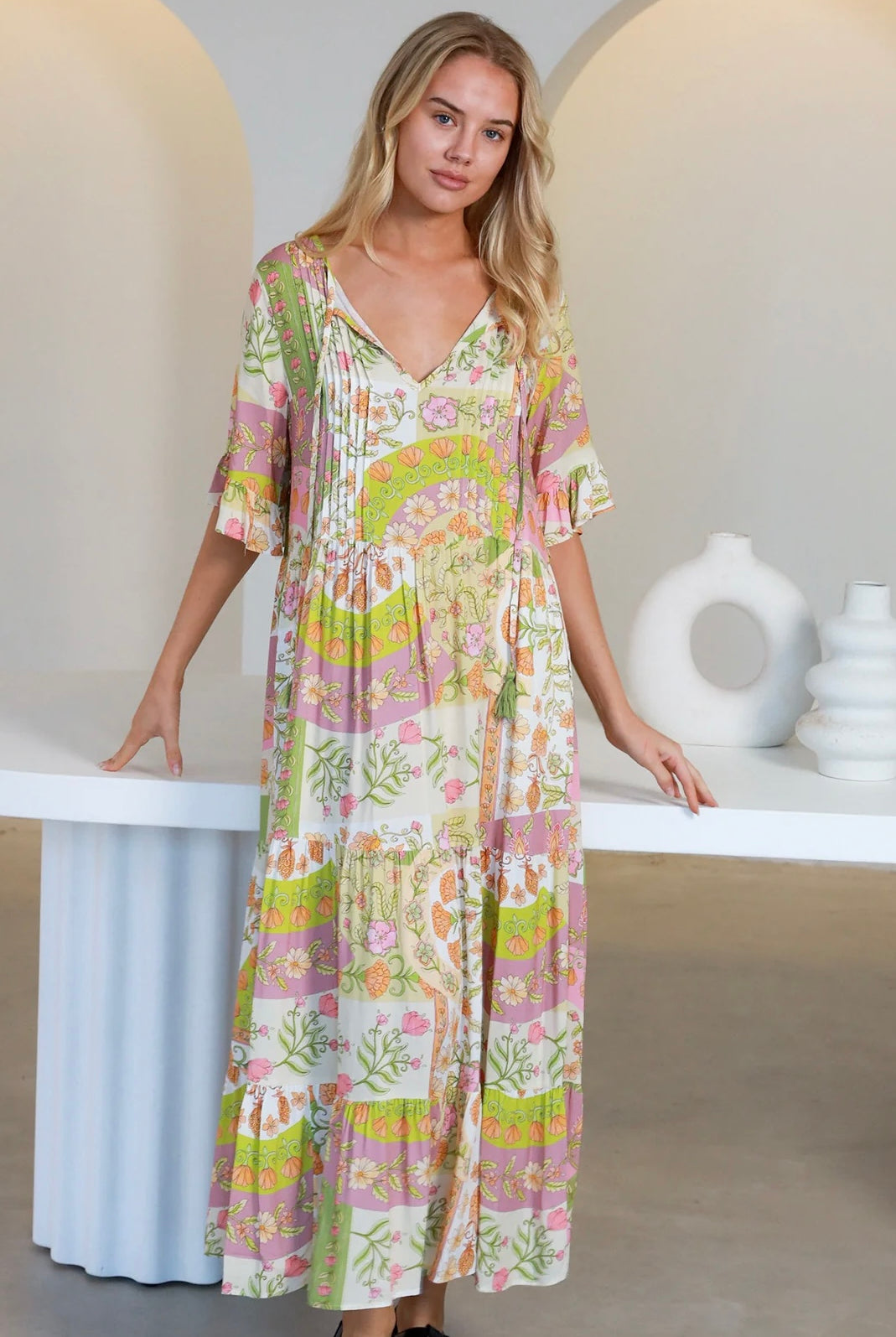 “Woman in vintage floral boho midi-maxi dress with tassel ties, frilled sleeves and tiered skirt – boho midi dresses Australia”