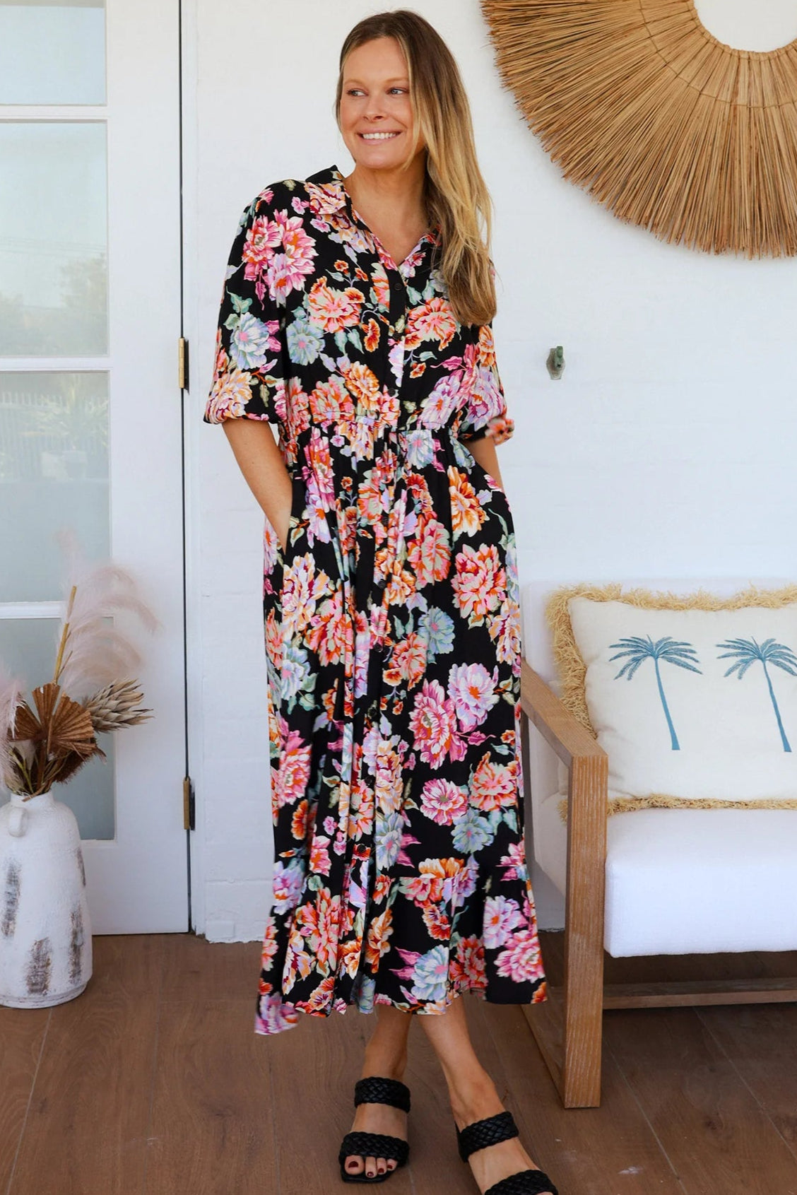 Black floral boho midi dress with painterly blooms, button front, frill hem, drawstring waist, half sleeves and pockets.