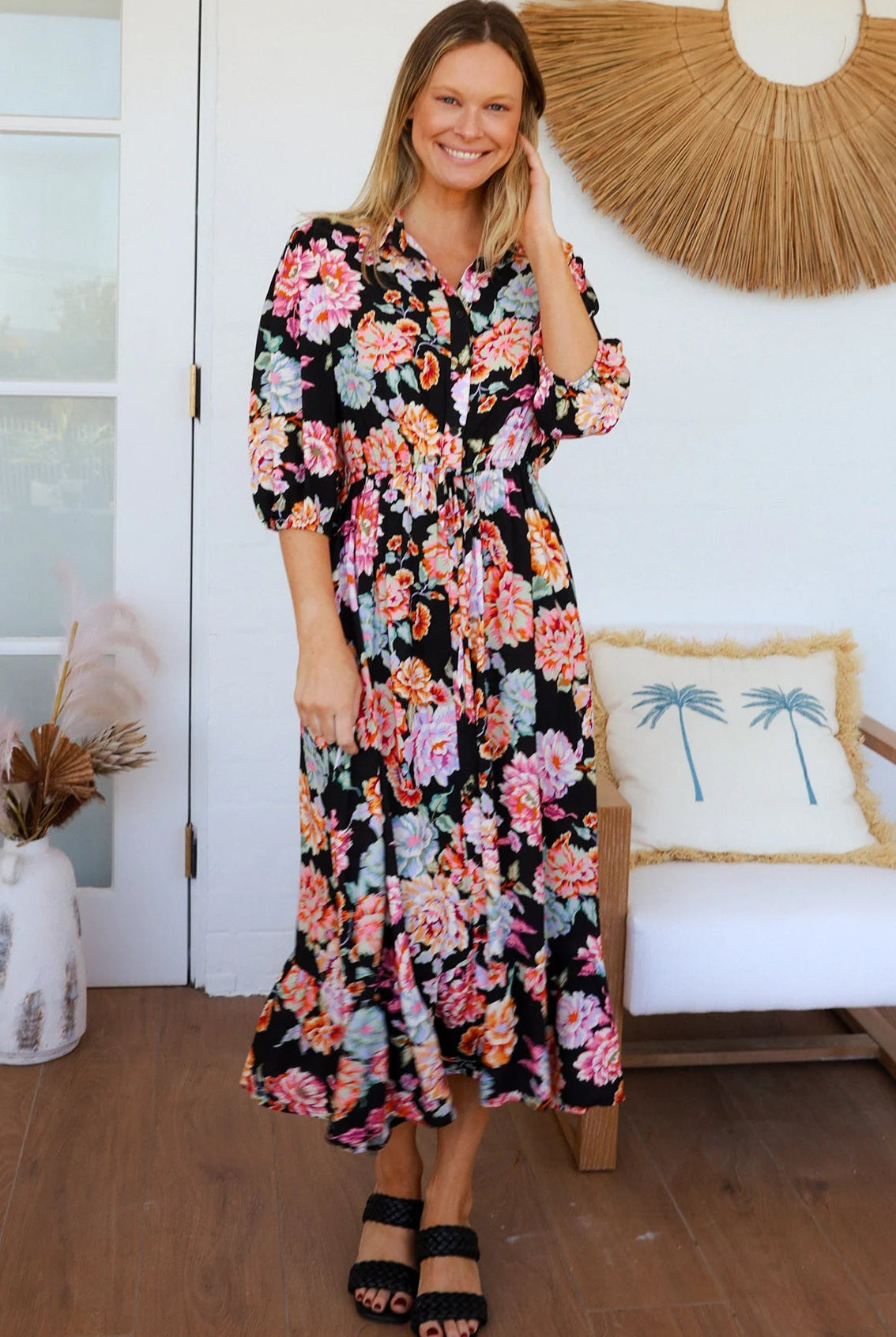 Black floral boho midi dress with painterly blooms, button front, frill hem, drawstring waist, half sleeves and pockets.