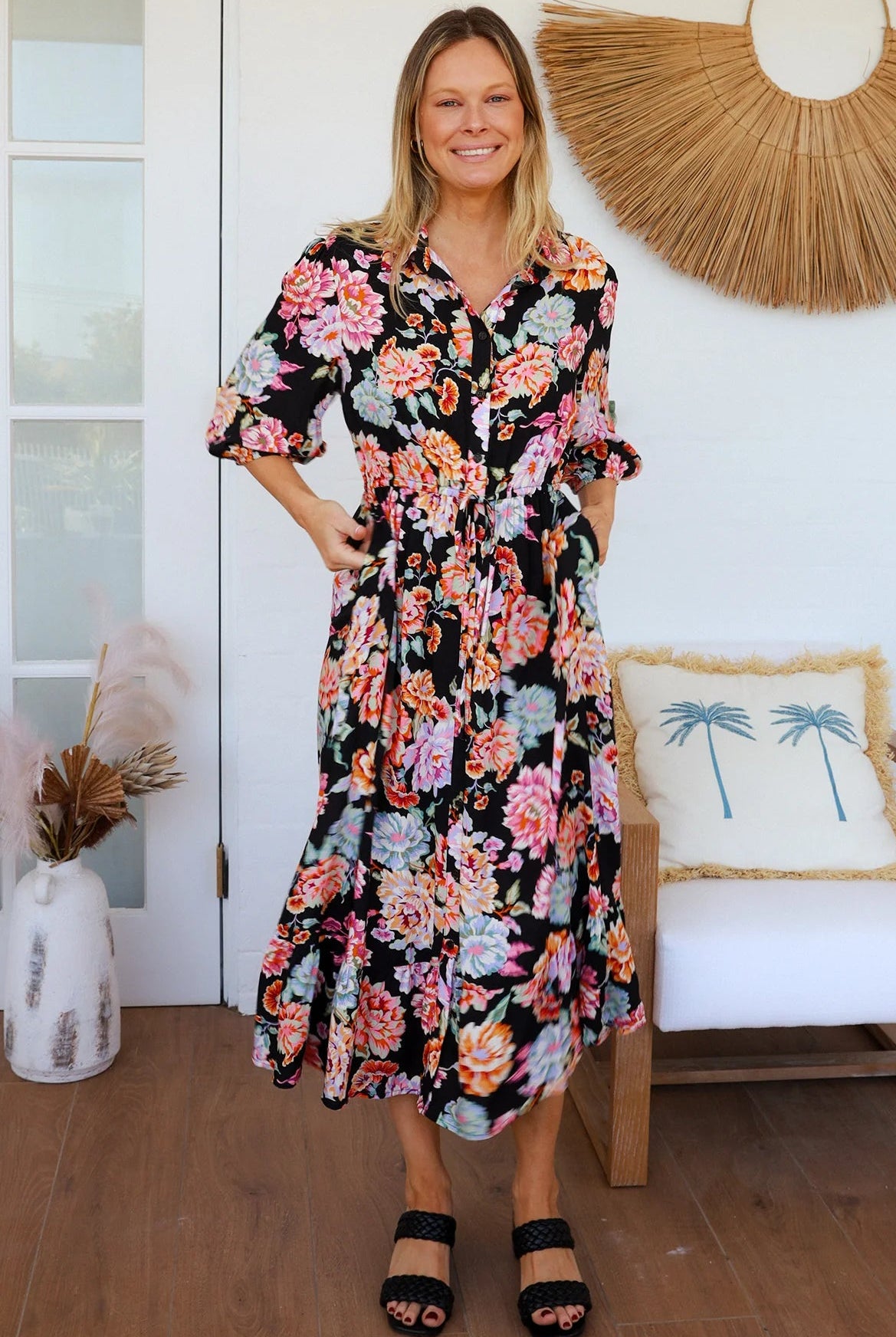 Black floral boho midi dress with painterly blooms, button front, frill hem, drawstring waist, half sleeves and pockets.