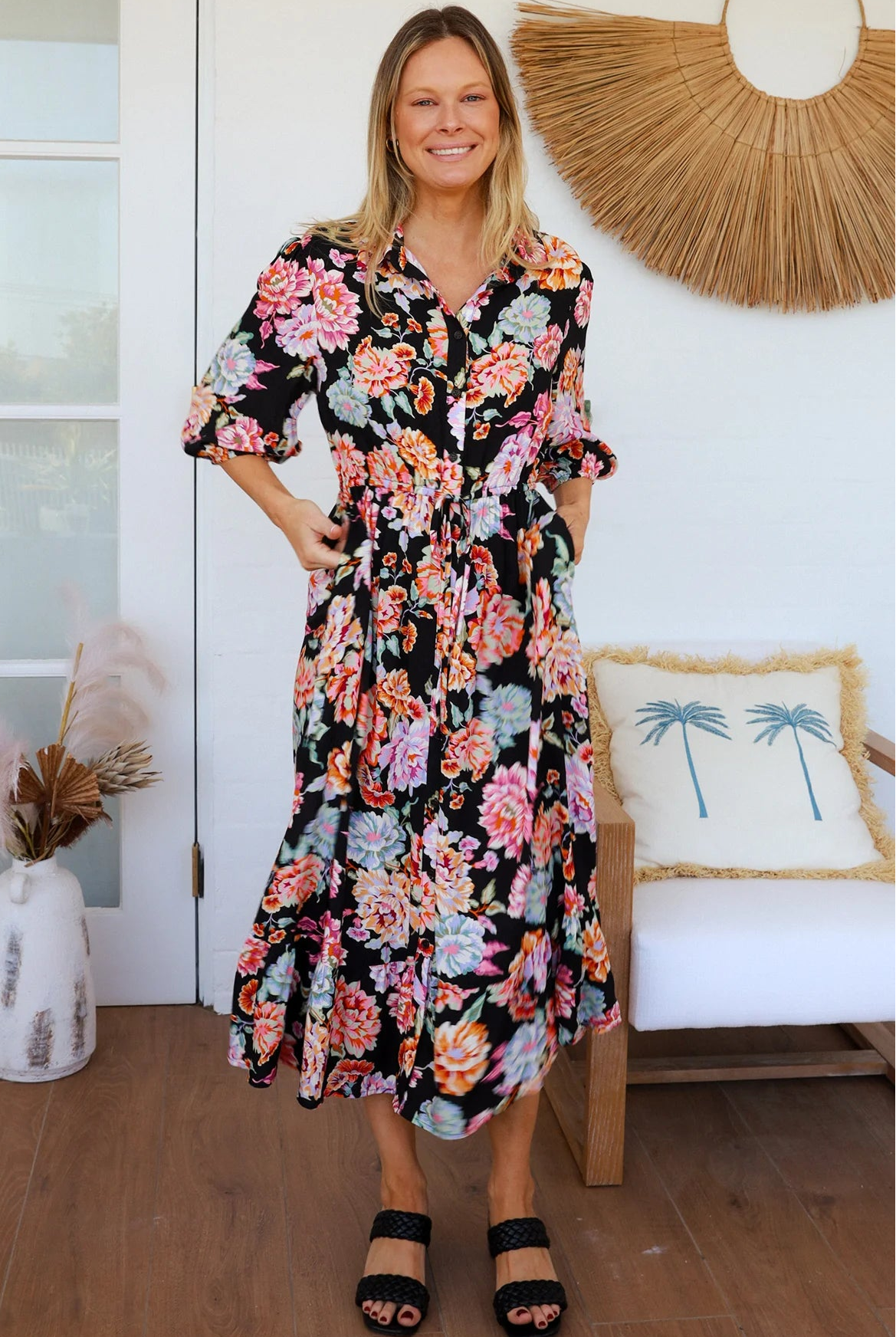Black floral boho midi dress with painterly blooms, button front, frill hem, drawstring waist, half sleeves and pockets.