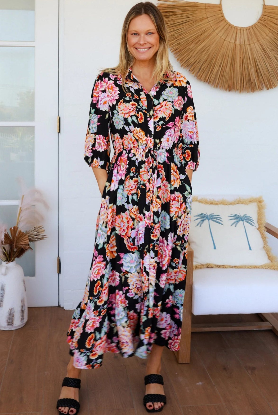 Black floral boho midi dress with painterly blooms, button front, frill hem, drawstring waist, half sleeves and pockets.