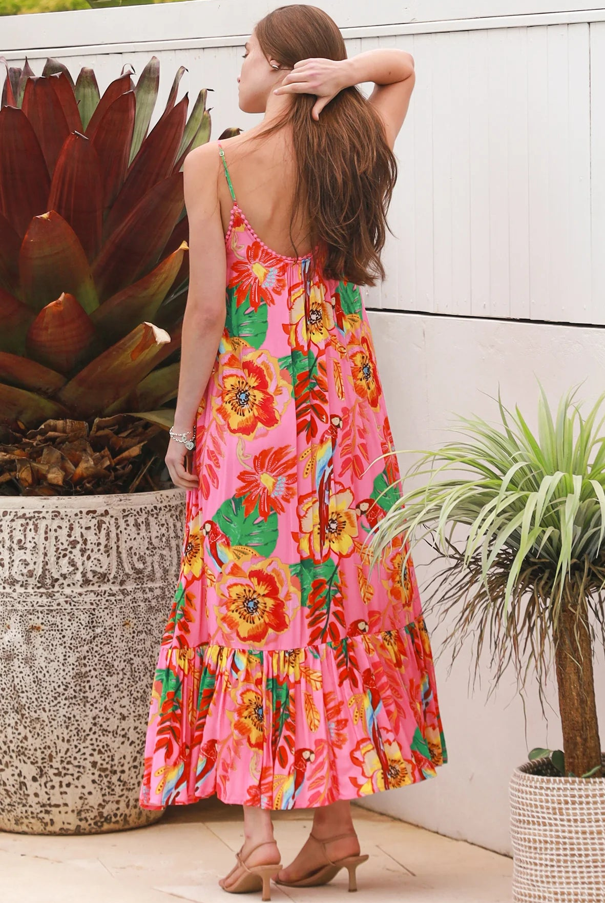 Pink floral slip maxi dress with poppy and parrot print, adjustable shoestring straps and crochet trim neckline