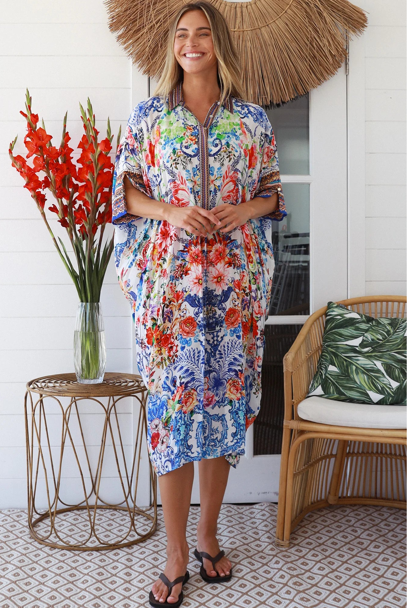 Woman in white viscose crepe kaftan midi dress with coral, jade and cobalt florals by Peacock Feathers Resort Luxe – Boho Dresses Australia