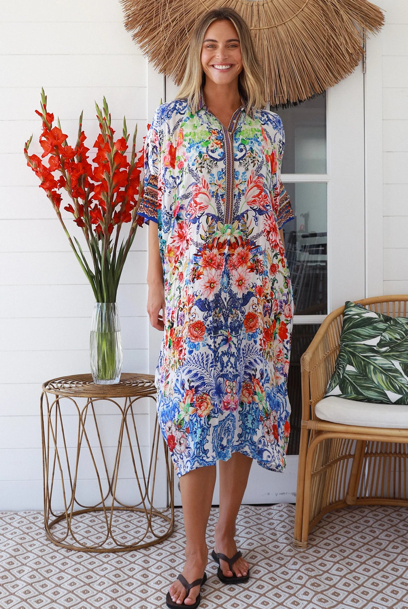 Woman in white viscose crepe kaftan midi dress with coral, jade and cobalt florals by Peacock Feathers Resort Luxe – Boho Dresses Australia