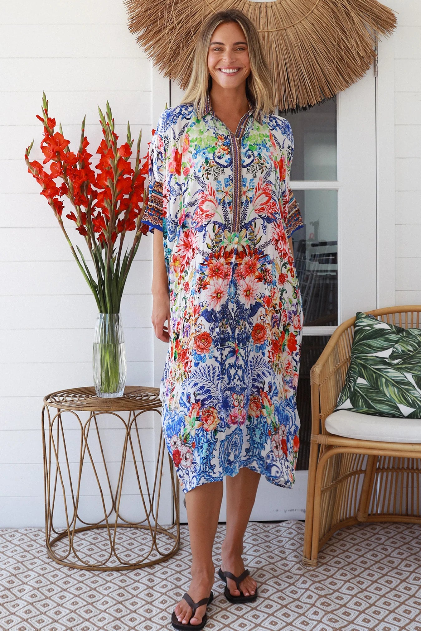 Woman in white viscose crepe kaftan midi dress with coral, jade and cobalt florals by Peacock Feathers Resort Luxe – Boho Dresses Australia