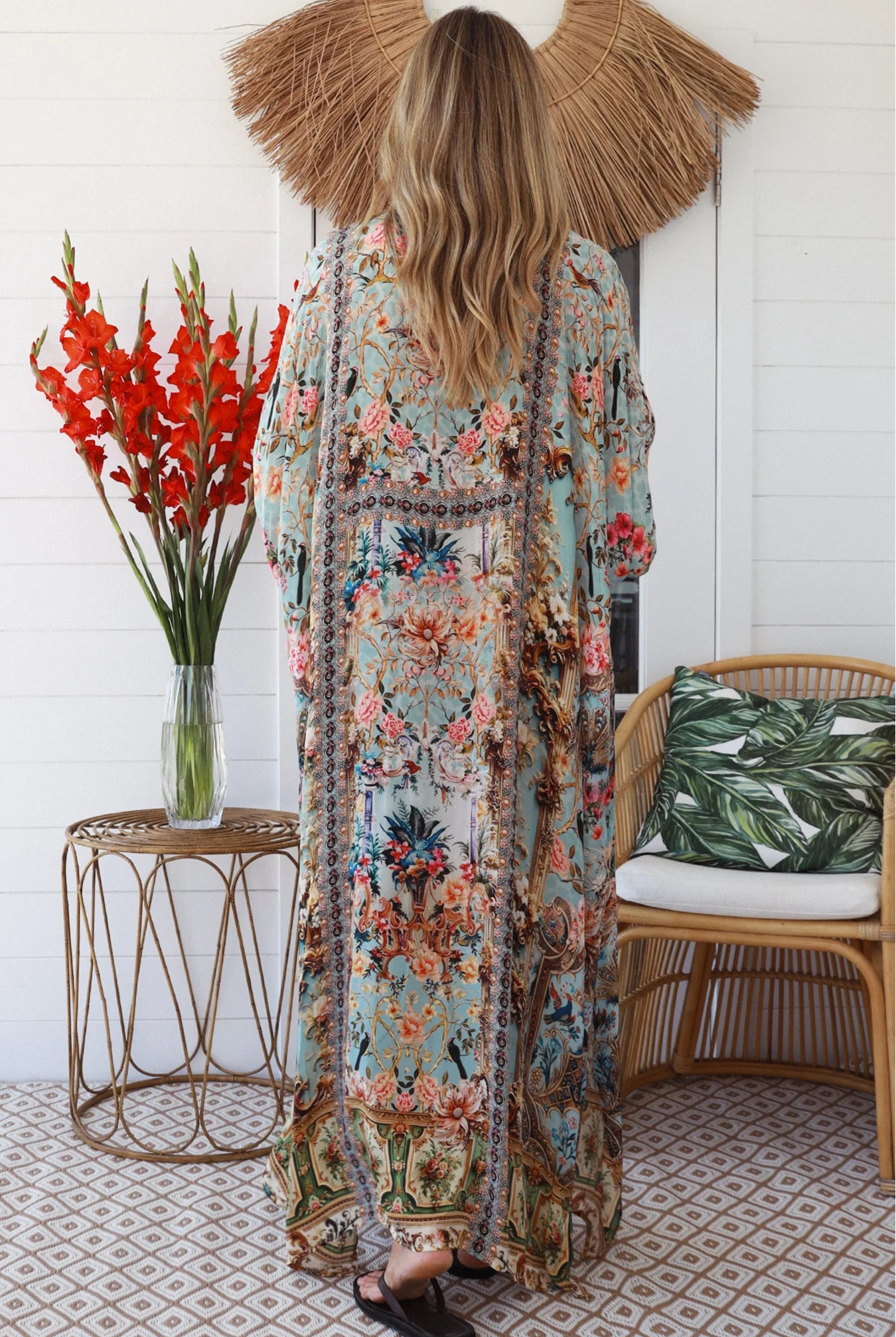Woman wearing turquoise floral resort luxe kaftan with tassel ties - boho resortwear Australia