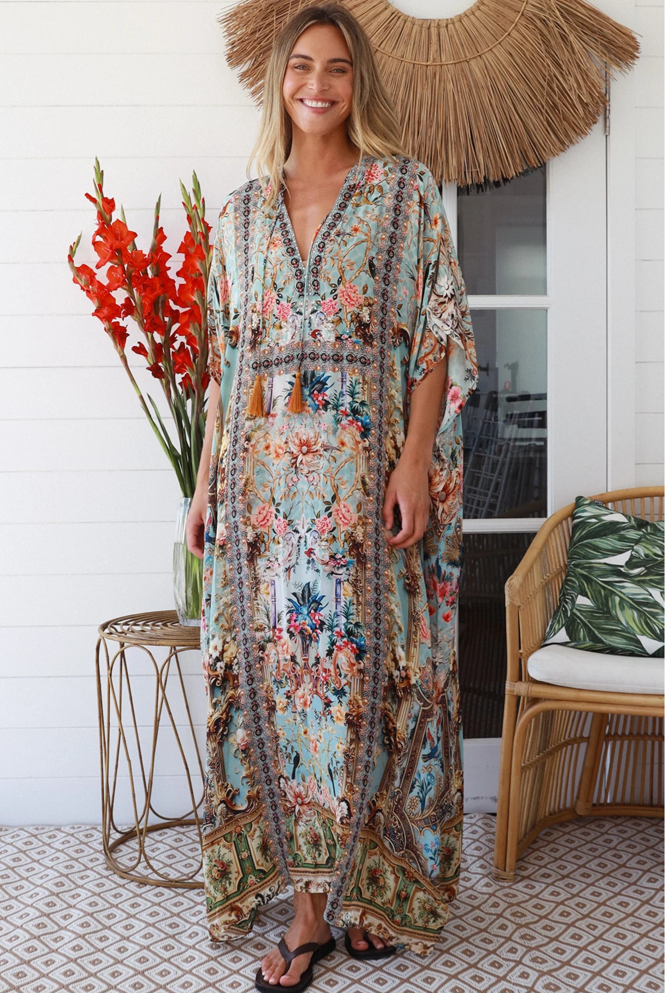 Woman wearing turquoise floral resort luxe kaftan with tassel ties - boho resortwear Australia