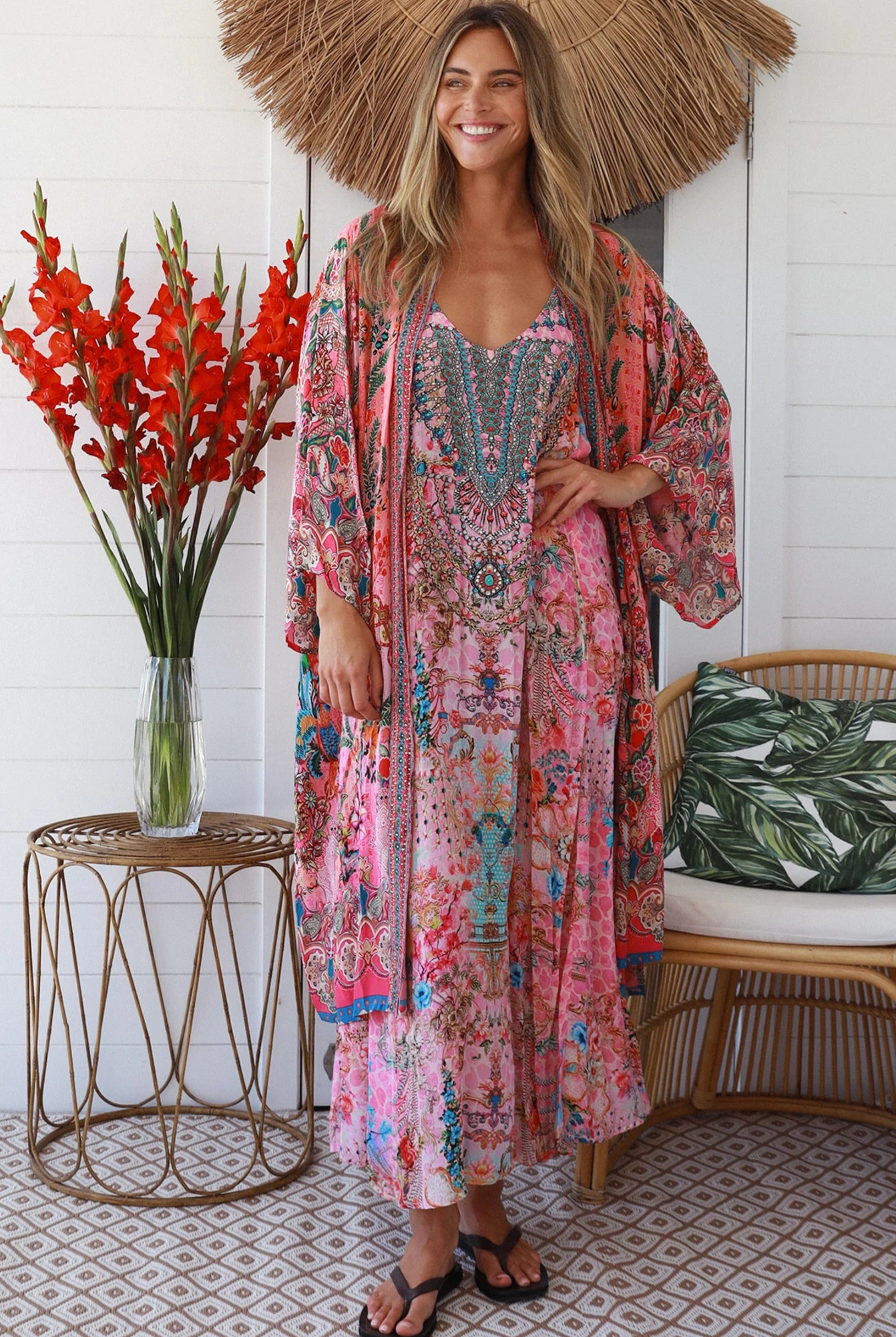 Woman in rose floral viscose-crepe kimono with turquoise accents and side splits - Peacock Feather Resort Luxe