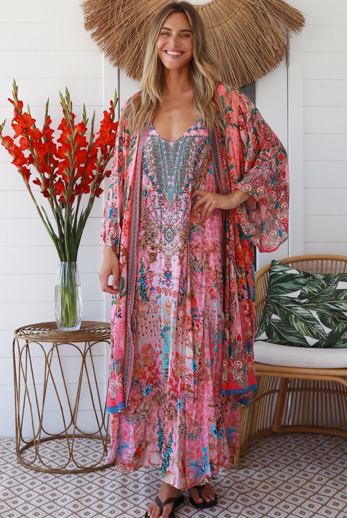 Woman in rose floral viscose-crepe kimono with turquoise accents and side splits - Peacock Feather Resort Luxe