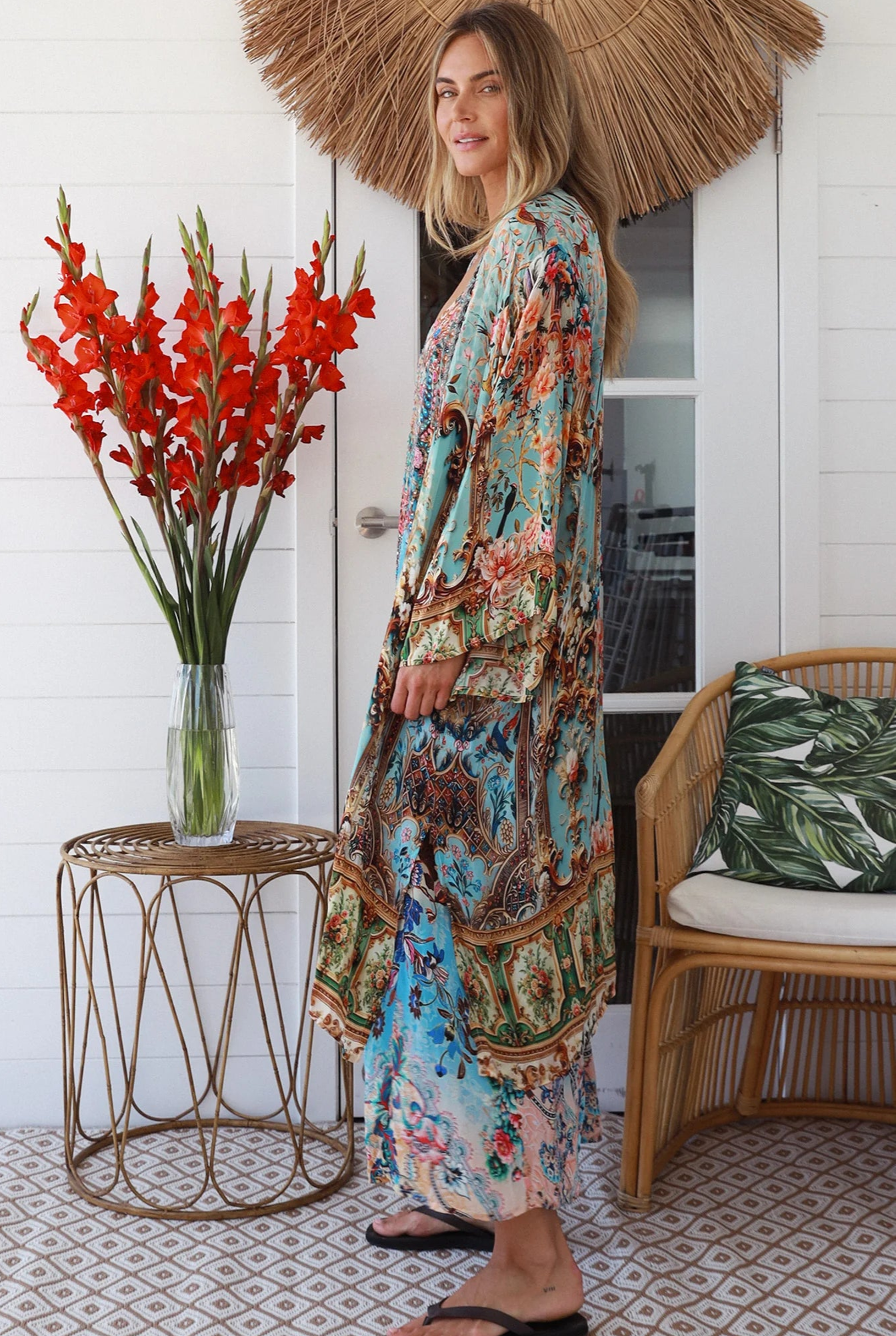Woman wearing blue floral crepe - viscose boho kimono with side splits - Peacock Feather Resort Luxe Australia.