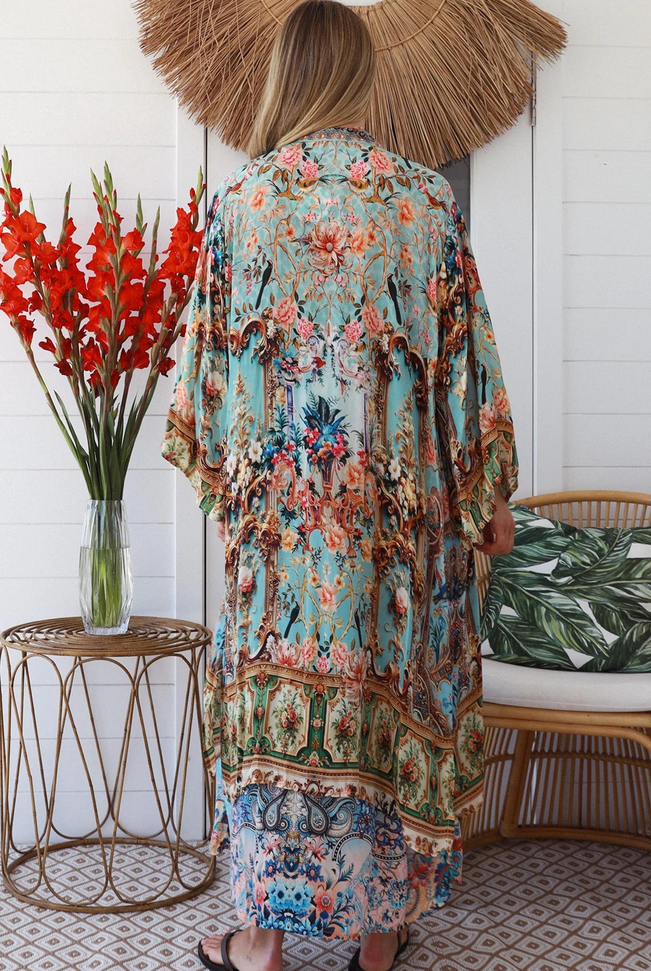 Woman wearing blue floral crepe - viscose boho kimono with side splits - Peacock Feather Resort Luxe Australia.