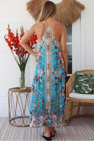 Woman wearing turquoise blue floral resort luxe midi dress with racerback straps - boho resort wear Australia